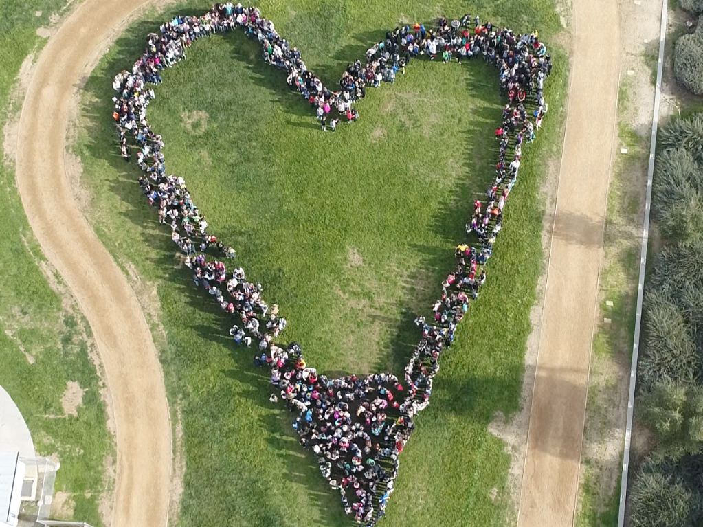 school students posing in a heart shape drone photo